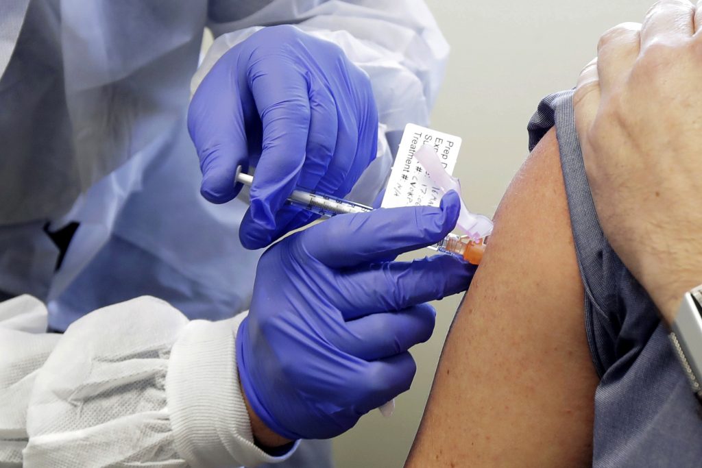 Medical personnel administering Coronavirus vaccine to a patient straightnews