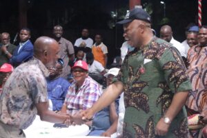 Sen Godswill Akpabio in a handshake with an APC supporter - straightnews