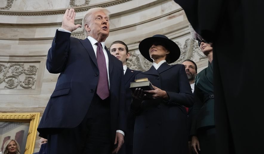 Reactions as Trump refused to swear on Bible during inauguration US President Donald Trump raising hand during swearing-in ceremony - Straightnews