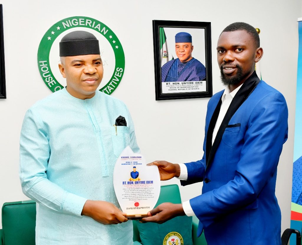 Rep Unyime Idem collecting the award from from Dr. Kwassi - Straightnews