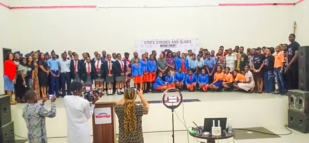 Book Enthusiasts, Scholars Task Akwa Ibom Students to Imbibe Good Reading Culture Uyo Book Club, Dr. Nana (middle) and others posing with the students - Straightnews
