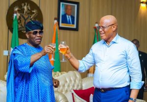 Senator Godswill Akpabio (l) and Governor Umo Eno (r) clinking glasses - Straightnews