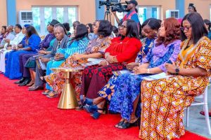 Mrs Eme Atakpo wearing red in the photo - Straightnews