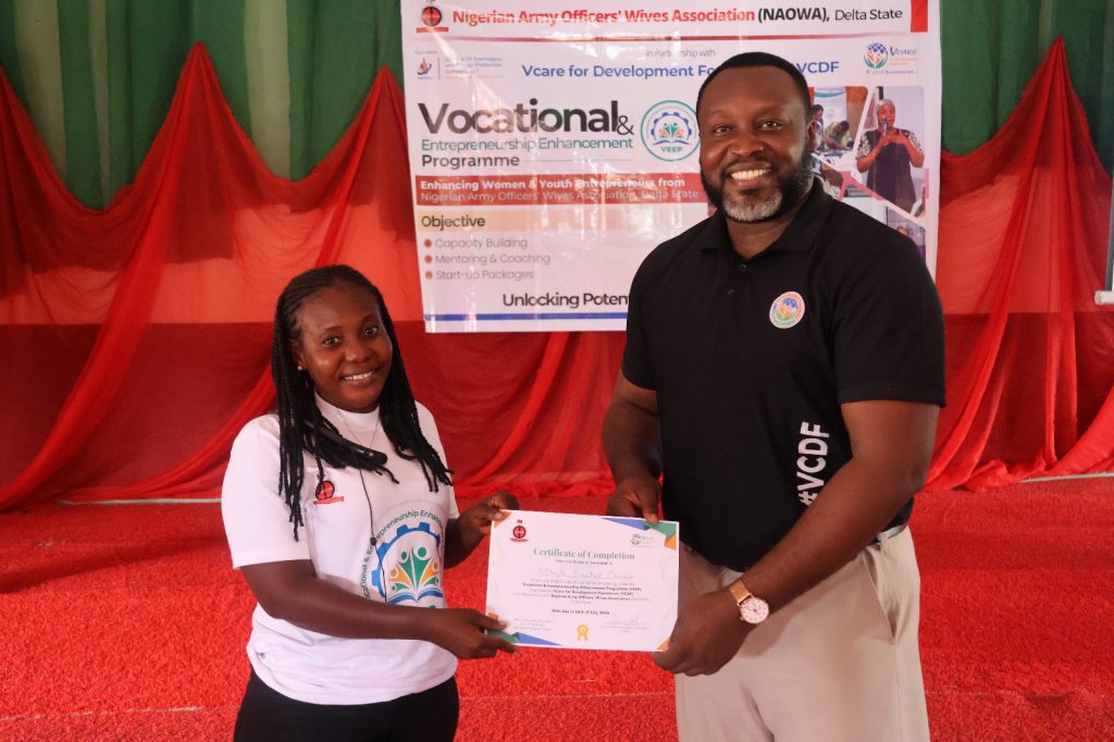 Mr. Philip Ukemezia, VCDF’s Deputy National Programmes Manager presenting a prize to NAOWA member - Straightnews